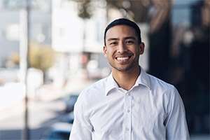 a smiling businessman standing outside